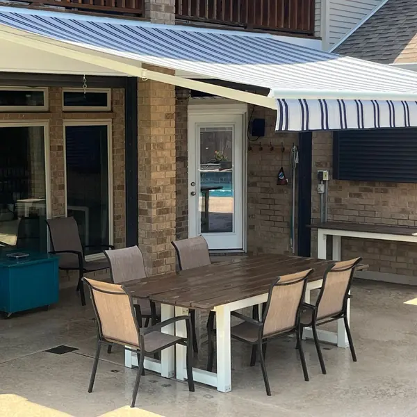 awning over table with five chairs