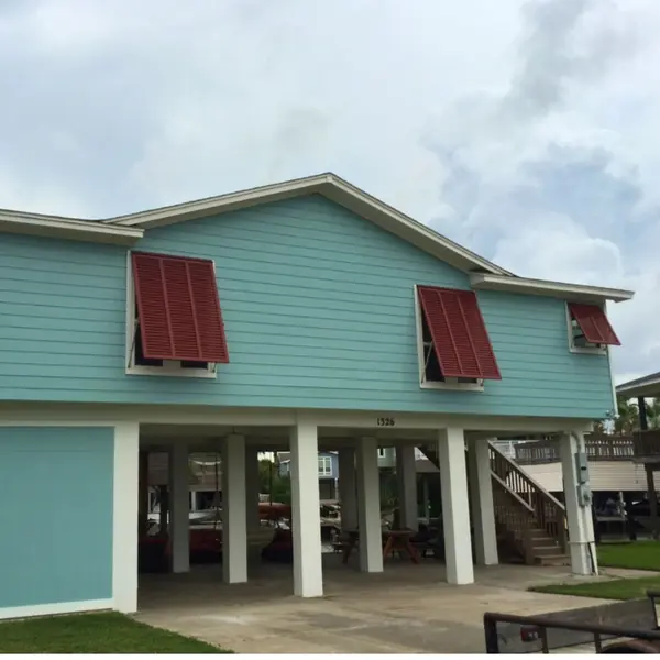 Red-brown shutters on a blue house