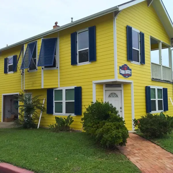 Navy blue shutters on a yellow house