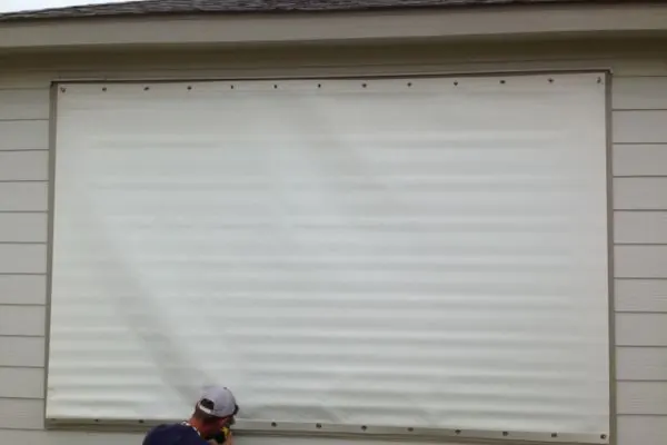Hurricane fabric panel anchored over a window